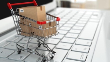 E-commerce. Shopping cart with cardboard boxes on laptop. 3d; Shutterstock ID 173225225; Purchase Order: Digital; Job: ; Client/Licensee: ; Other:
